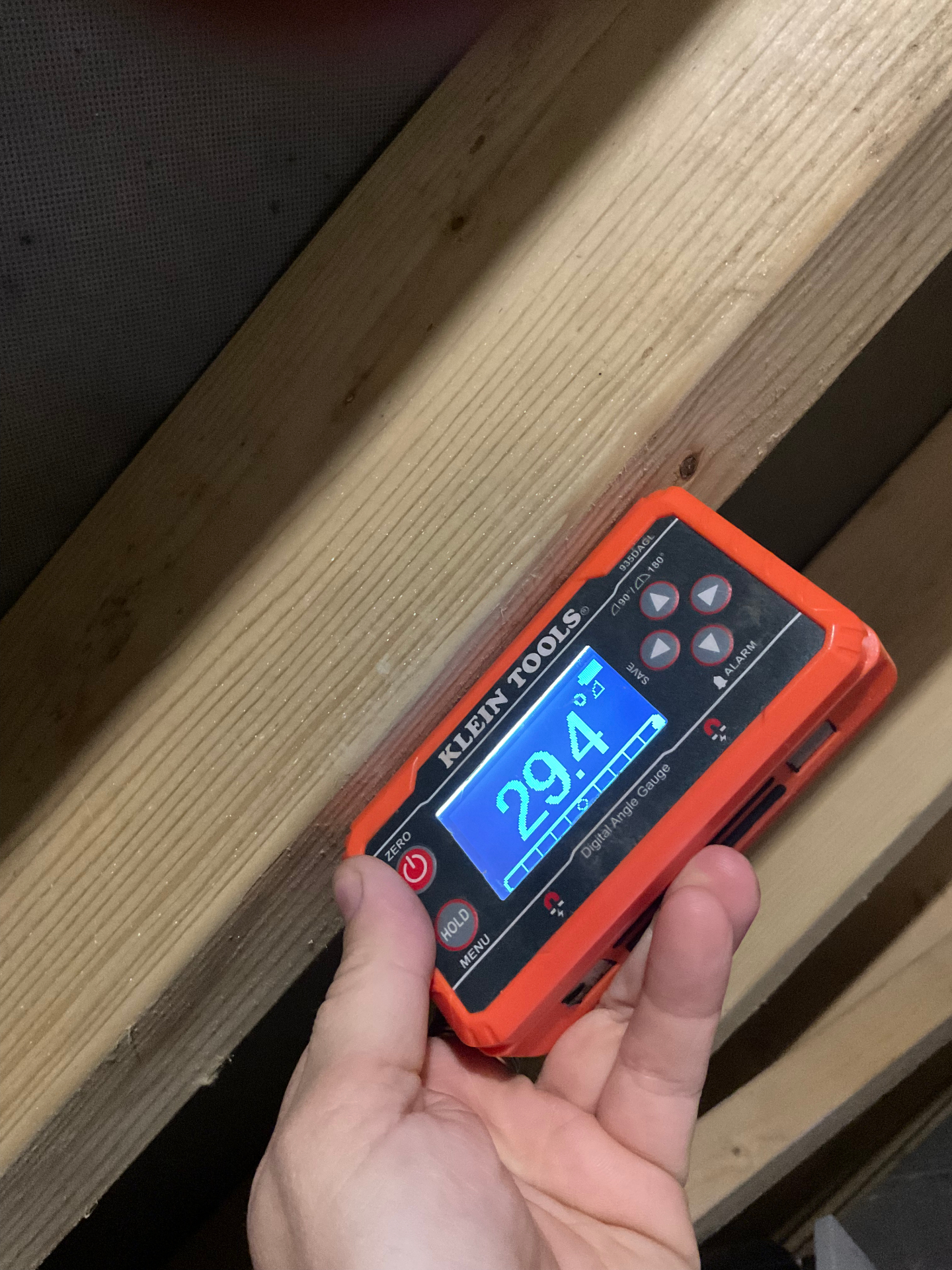 Roof pitch measurement being taken during a solar site survey in Devon