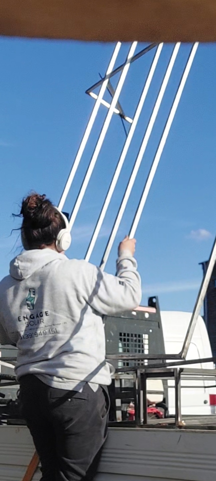 Engage Solar team member preparing solar mounting rails on site in Devon