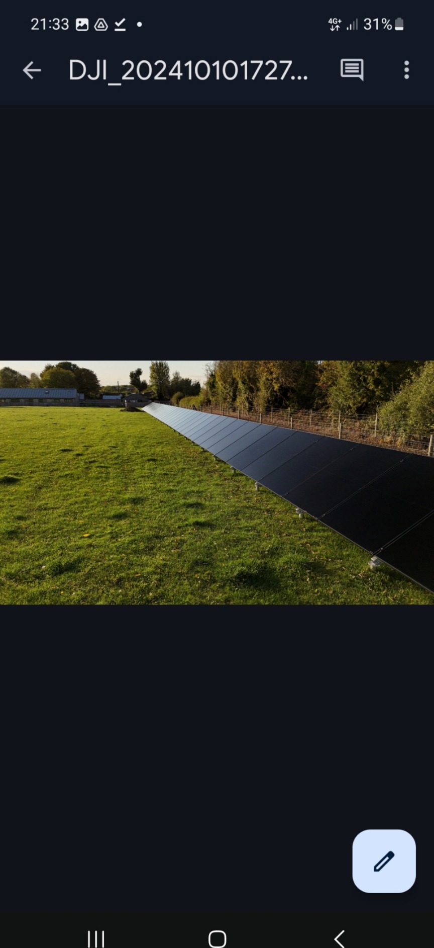 Long ground mounted solar array installed on open land in Devon